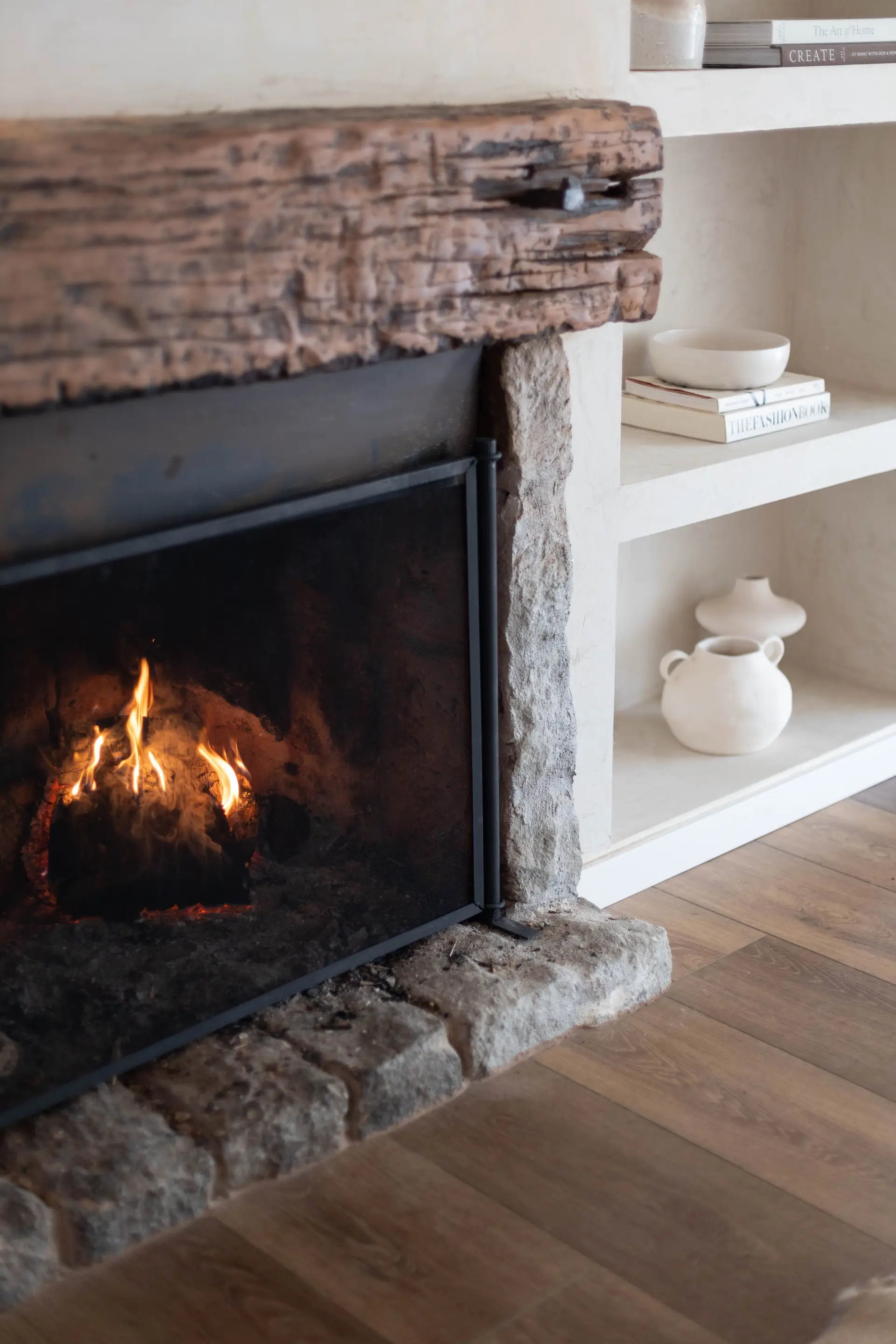 Warm sculptural fireplace and plaster walls in a quiet Canadian residential sanctuary