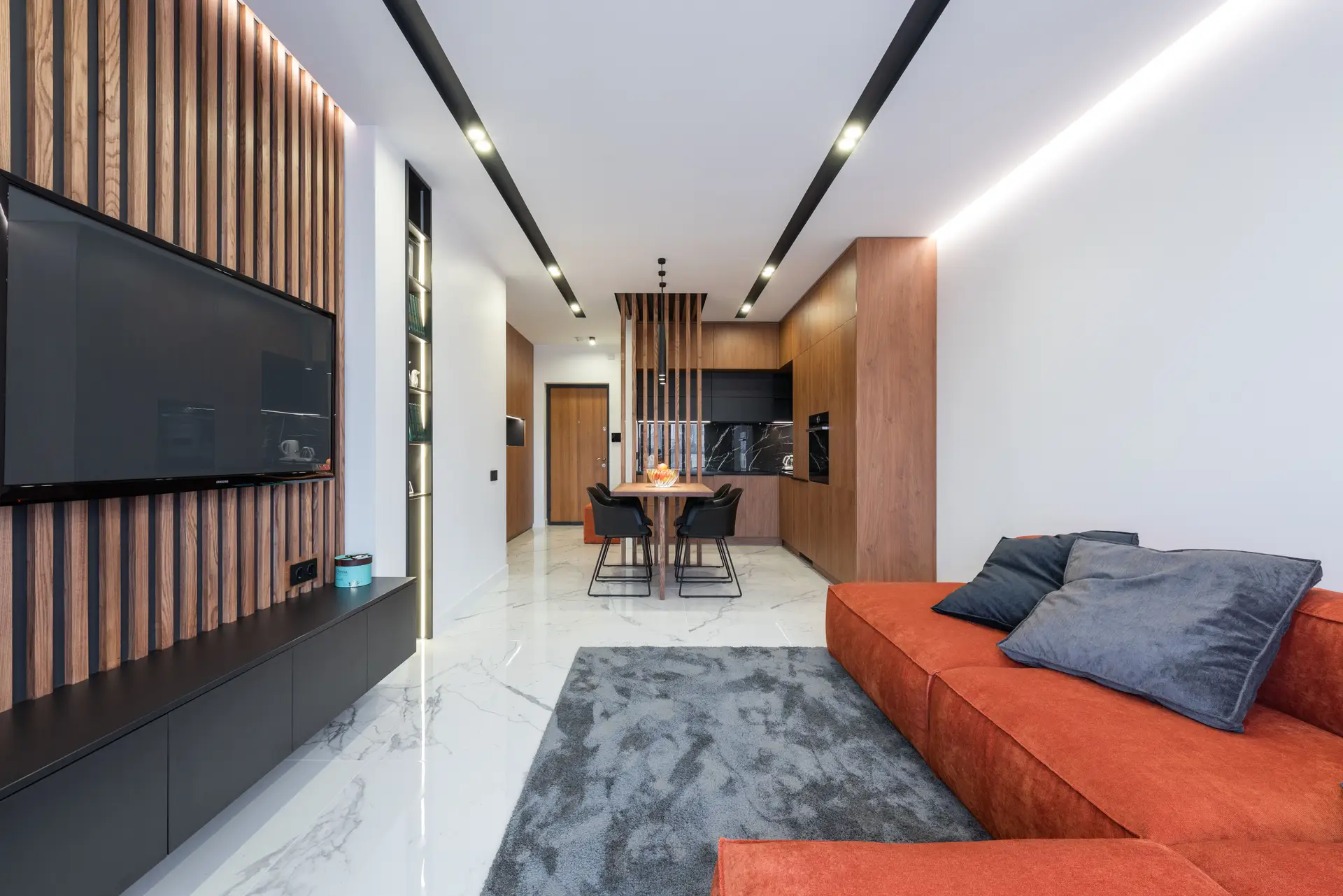 Living room before renovation showing cluttered partitions and low lighting