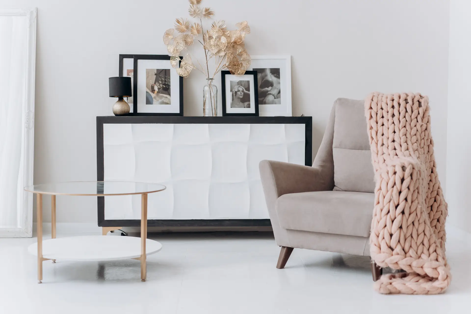 Warm beige armchair and handcrafted ceramic accessories demonstrating residential home styling details