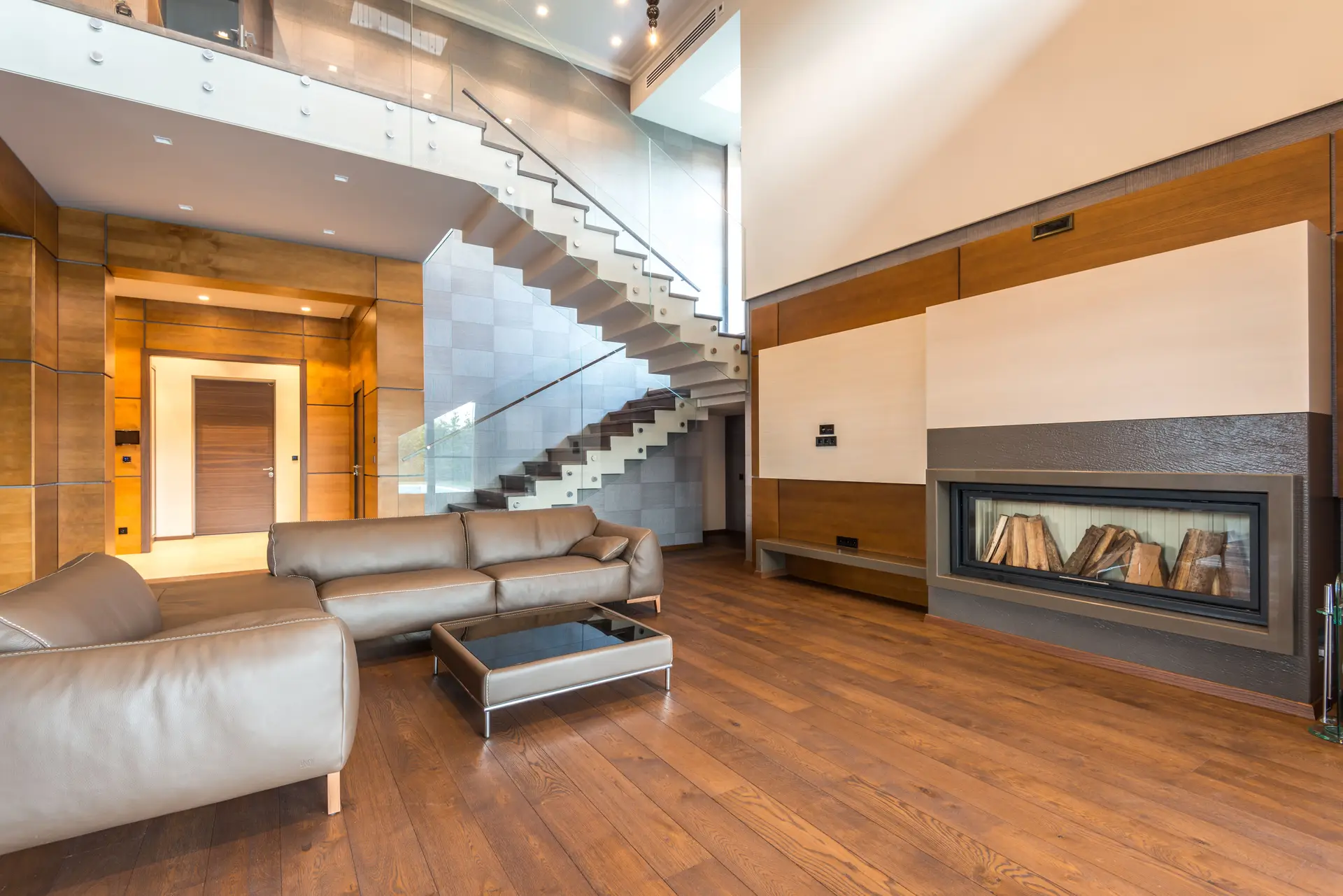 Completed living room after renovation showing seamless modern fireplace and neutral seating